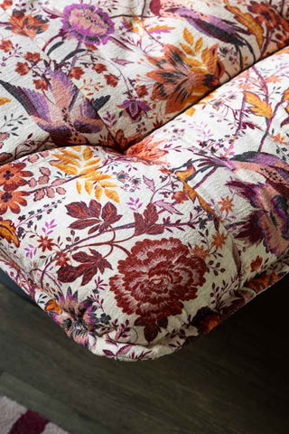 The corner detail of the Charleston Garden Floral Velvet Swivel Chair, showing the floral and bird print. 