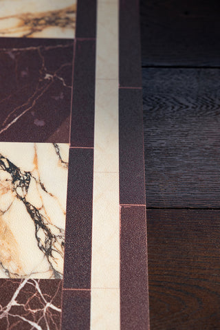 A close up of the edge of the Image of Checkered Burgundy Marble Effect Durable Floor Mat. 