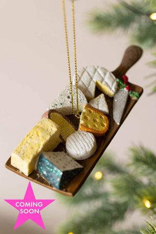 The Cheese Board Christmas Decoration shown with a pink star icon that reads 'coming soon'.
