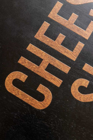 The text of on the Cheese Slut Square Wooden Serving Board. 