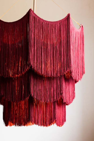 Detail showing the tiered fringing on the Cherry Red Tiered Fringe Chandelier. 