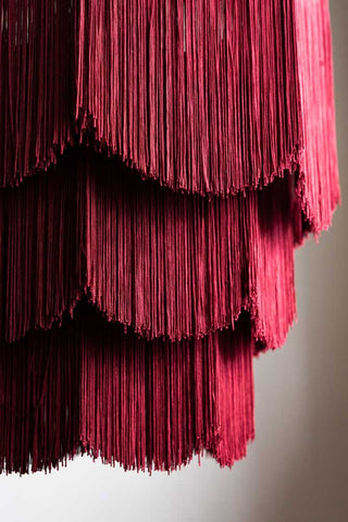 A close up detail of the scalloped fringing on the Cherry Red Tiered Fringe Chandelier.