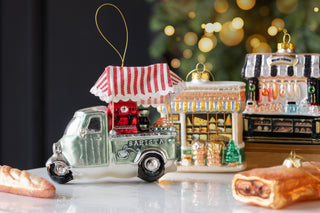 A barista truck christmas decoration made from glass. 