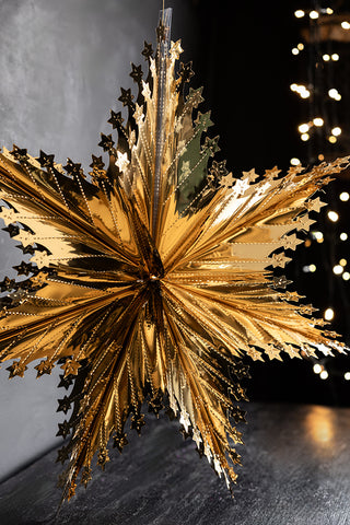 Lifestyle image of the Christmas Star Hanging Decoration in Metallic Gold