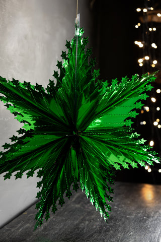 Lifestyle image of the Christmas Star Hanging Decoration in Metallic Green