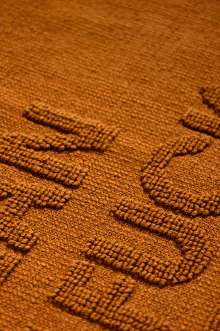 Close-up of a brown bath mat.
