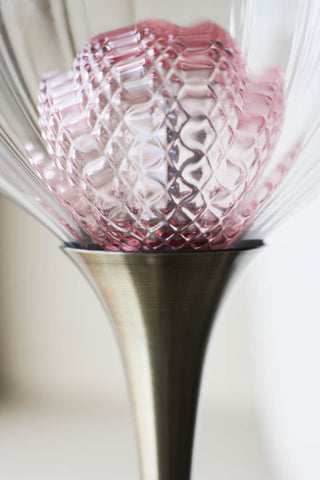 The pink bulb of the cocktail table lamp.
