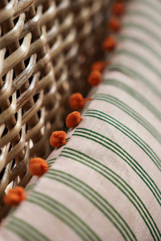 Detail image of the Cotton Green Stripe Cushion with Orange Pom-Poms