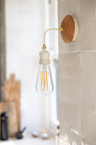 Lifestyle image of the Cream Metal & Glass Wall Light.