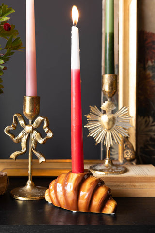 Image of the Croissant Candle Holder with a lit candle