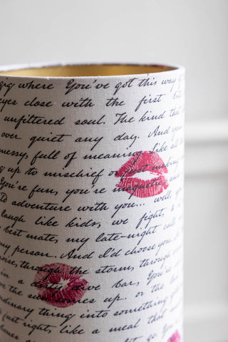 A detail shot of the shade of the Curve Black Table Lamp With Love Letter Shade, showing the love letter text and kiss marks. 