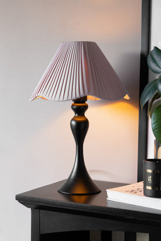 Lifestyle image of the Curved Table Lamp With Pink Pleated Lampshade
