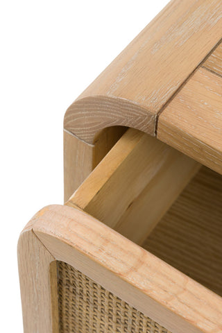 Close-up of the open drawer of the Curved Wood & Rattan Chest Of Drawers, on a white background.