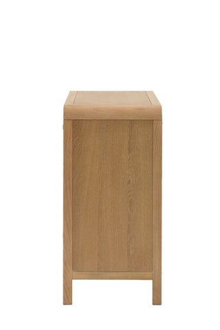Cutout of the Curved Wood & Rattan Chest Of Drawers seen from the side, on a white background.