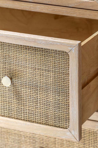 Close-up of an open drawer on the Curved Wood & Rattan Chest Of Drawers.