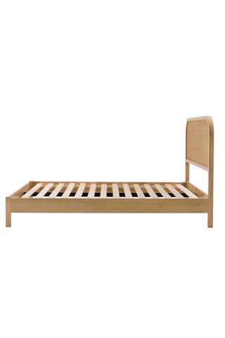 The Curved Wood & Rattan Bed seen from the side, on a white background.