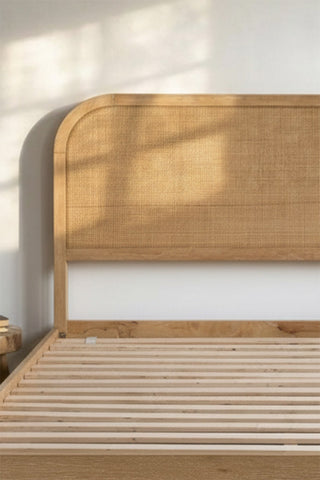 Close-up of the Curved Wood & Rattan Bed frame.