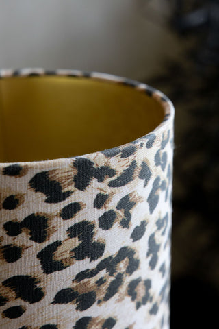 Detail of the leopard shade and gold shade interior of the Curve Red Table Lamp With Leopard Shade. 