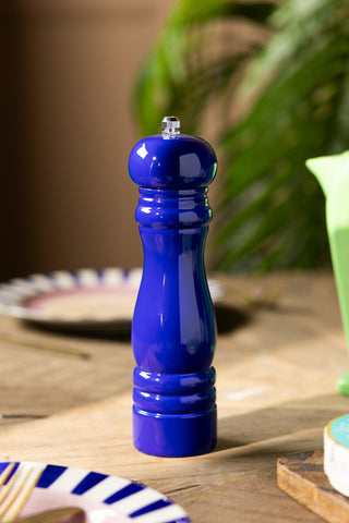 The Dark Blue Salt/Pepper Mill styled on a dining table with various other accessories.
