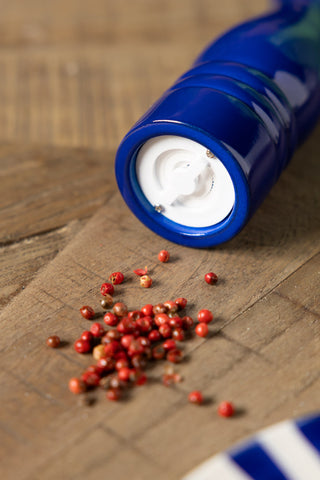 The Dark Blue Salt/Pepper Mill styled with peppercorns.