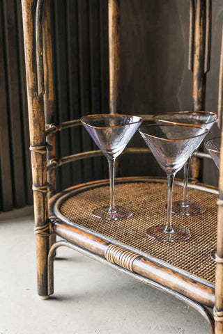 Close-up image of the Dark Brown Rattan Console/Drinks Table styled with cocktail glasses.