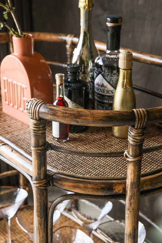 Close-up image of the Dark Brown Rattan Console/Drinks Table styled with bar accessories.