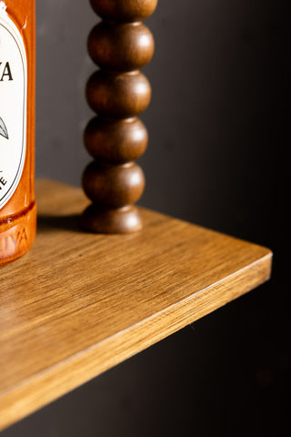 The corner detail of the Dark Wood Bobbin 2-Tier Wall Shelf. 