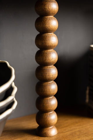 The bobbin detail of the Dark Wood Bobbin 2-Tier Wall Shelf. 