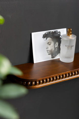 The Dark Wood Bobbin Floating Shelf shown close up with the bobbin detailing.
