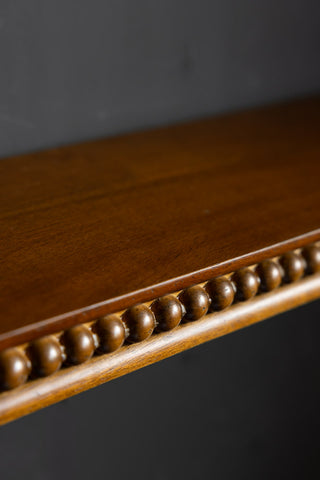 The Dark Wood Bobbin Floating Shelf, showing the bobbin detail on the edge of the shelf. 
