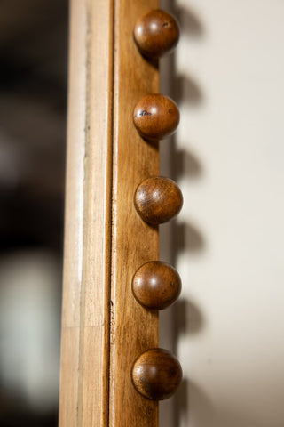 The bobbin frame of the Dark Wood Bobbin Mirror With Shelf. 