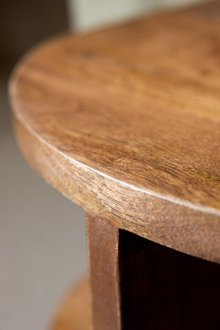 A close up of the corner curve of the Dark Wood Shelf Side Table