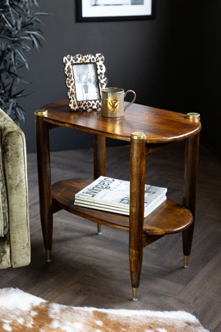 Lifestyle image of the Dark Wood & Brass Oval Side Table