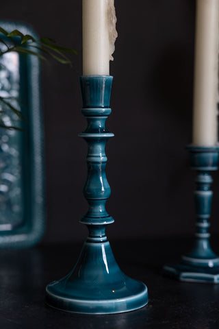 Detail shot of the Tall Deep Blue Enamel Cast Style Candlestick Holder, with the short version and a matching tray in the background.