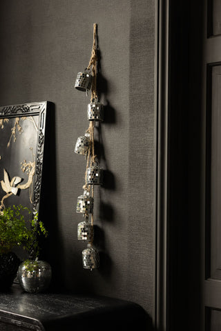 The Disco Bells Christmas Decoration shown against a black wall. 