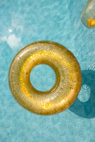 Lifestyle image of the Disco Gold Inflatable Pool Ring