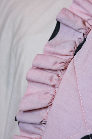 A close up of the Dot Noir Ruffled  Bedspread, showing the ruffled edge.