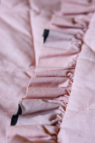 A detail shot of the ruffled detailing on the Dot Noir Ruffled  Bedspread.