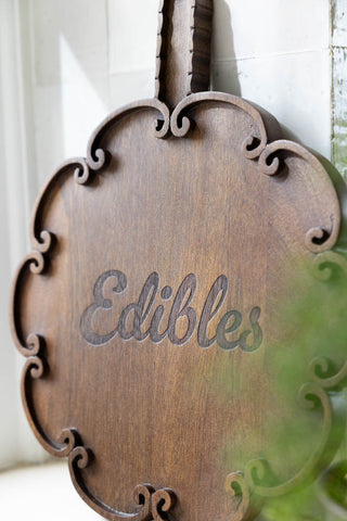 Zoomed in image of he Edibles Scalloped Wooden Serving Board in a kitchen. 