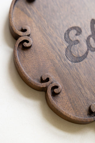 The scrolled, scalloped edges of the Edibles Scalloped Wooden Serving Board.