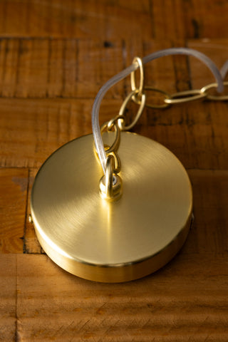 The ceiling fixture and chain of the Elegant Frosted Amber Leaf Ceiling Light, displayed on a wooden surface.