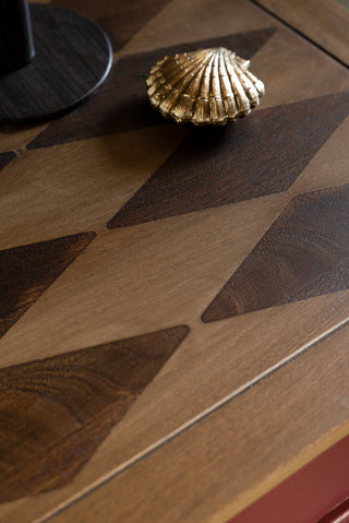 The harlequin wood detailing on the top of the Emporium Brick Red Coffee Table. 