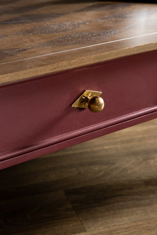 The drawer and gold handle on the Emporium Brick Red Coffee Table. 