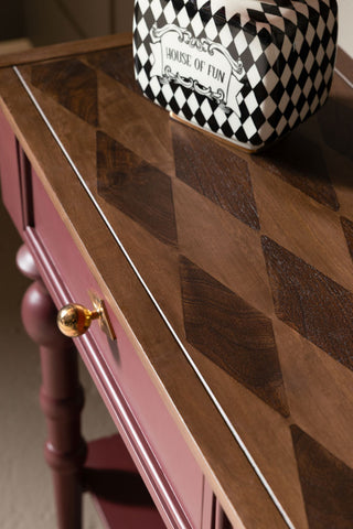 The harlequin detail on the top of the Emporium Brick Red Console Table. 