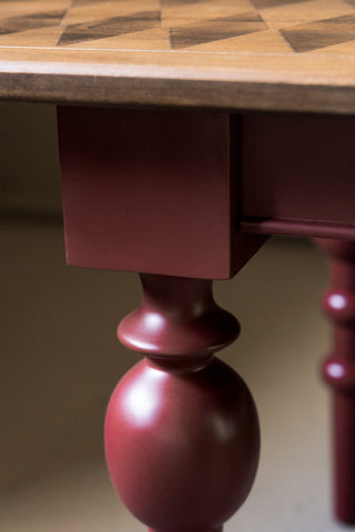 The legs of the Emporium Brick Red Console Table. 