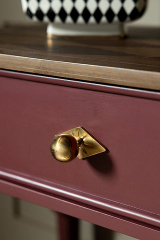 The gold handle on the Emporium Brick Red Console Table. 