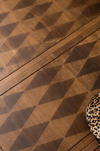 The harlequin wood detailing on the top of the Emporium Brick Red Extendable Dining Table . 