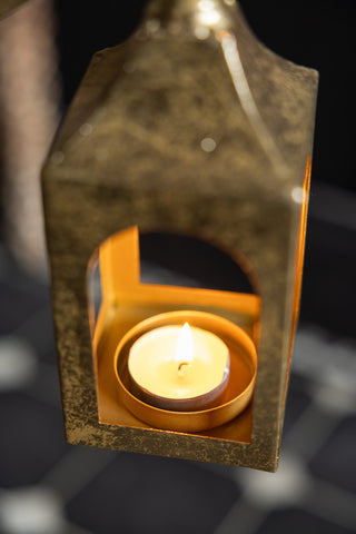 Close-up of a lit candle inside the lantern of the Extra Large Gold Angel Decorative Lantern.
