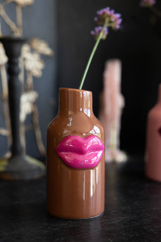 Lifestyle image of the Small Brown Ceramic Vase With Lips.