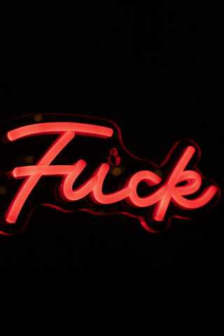 Neon sign with the word 'Fuck' in red on a black background